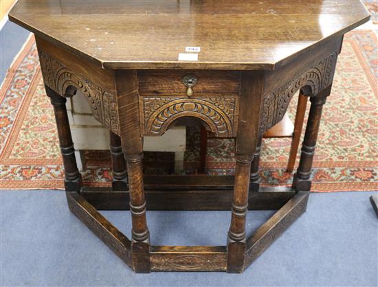 A 17th century style oak single drop leaf credence table, W.92cm